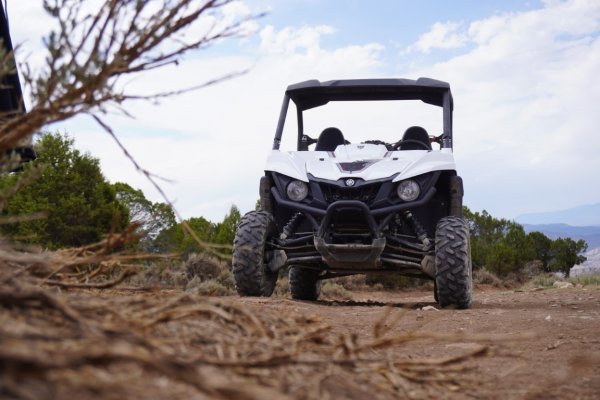 White UTV parked outside on a trail